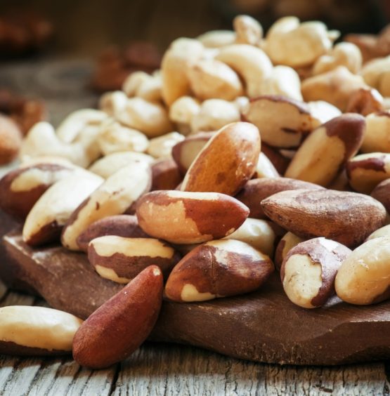 Brazilian nut, nut mix, vintage wooden background, selective focus